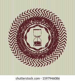 Red sand clock icon inside distressed grunge seal