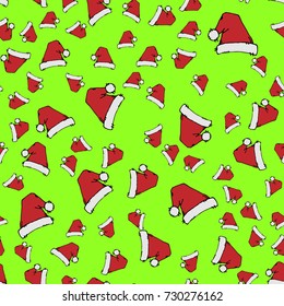 Red Santa hats on green background. Seamless pattern. Hand drawn vector stock illustration