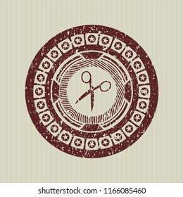 Red scissors icon inside distress rubber stamp