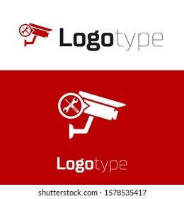 Red Security camera with screwdriver and wrench icon isolated on white background. Adjusting, service, setting, maintenance, repair, fixing. Logo design template element. Vector Illustration