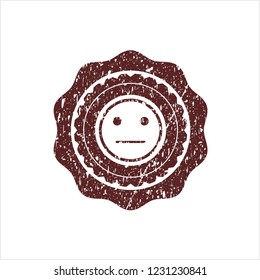 Red serious face icon inside distressed rubber grunge texture stamp