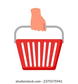 Red shopping basket in human hand. Shopping concept.