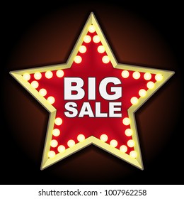 The red sign in the shape of a star illuminated bulbs in vintage style. The inscription Big sale.