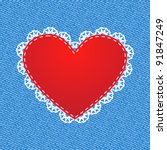 Red silk heart with lace on denim background