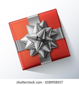 Red small square gift box with big glittering silver bow and ribbons isolated on white background. Top view. Vector realistic festive illustration. Decoration element for holiday design.