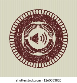 Red sound icon inside distressed grunge stamp