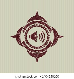 Red sound icon inside distressed rubber stamp