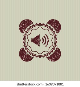 Red sound icon inside distressed grunge seal