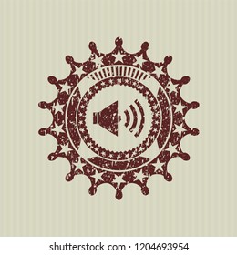 Red sound icon inside rubber seal with grunge texture