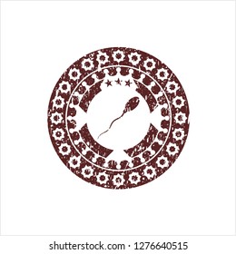 Red sperm icon inside distress rubber stamp with grunge texture