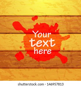 Red splash stain on wooden background-text space ,banner
