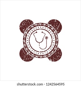 Red stethoscope icon inside distress rubber grunge texture stamp