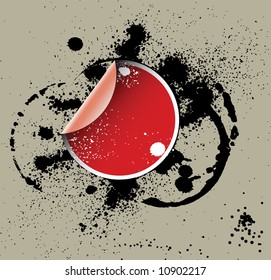 Pegatina roja sobre un fondo grueso con manchas de tinta