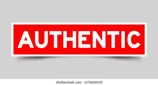 Red sticker with word authentic on gray background