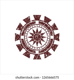Red sun icon inside distressed rubber grunge seal