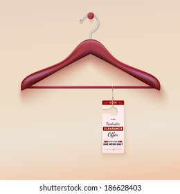 Red tag with special offer sign hanging on wooden hanger