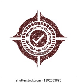 Red tick icon inside distressed rubber seal with grunge texture