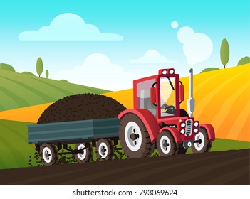 Red tractor with a trailer on the field going up the hill. Harvesting on the farm. Beautiful scenery of the hills. Agriculture.