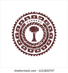 Red tree icon inside distress rubber seal
