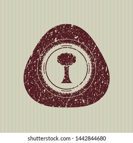 Red tree icon inside distress rubber seal with grunge texture