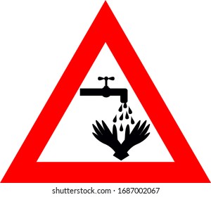 Red triangle sign recommending prevention of washing hands with water and antibacterial soap during dangerous  corona virus SARS-COV-2 pandemic time which is causing COVID-19 disease