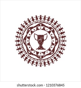 Red trophy icon inside distress rubber stamp