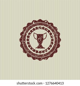Red trophy icon inside distressed rubber seal