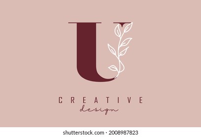 Red U letter logo design with white leaves branch vector illustration. Creative and elegant icon with letter U.