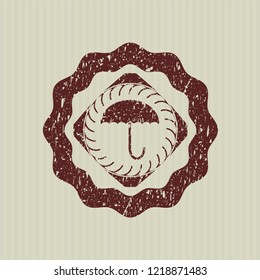 Red umbrella icon inside rubber grunge texture stamp