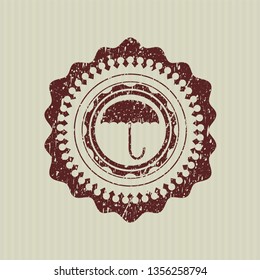 Red umbrella icon inside rubber grunge stamp