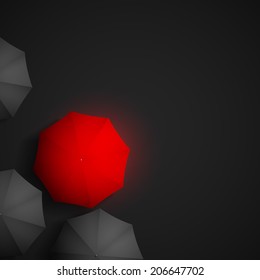red umbrella on a background of black umbrellas