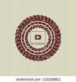 Red video player icon inside distressed rubber grunge texture stamp
