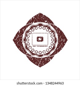 Red video player icon inside grunge style stamp