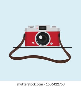 red vintage camera with camera strap vector