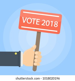 Red vote 2018 sign board in hands.