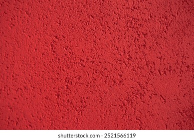 Red wall texture. Red rough background. Red grain surface. Concrete red wall. Texture of the wall.