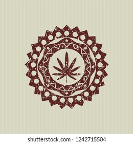 Red weed leaf icon inside distress rubber seal