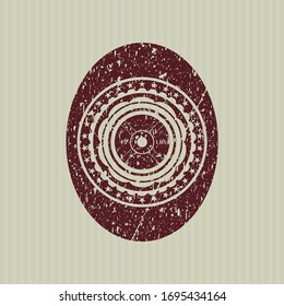 Red weightlifting or powerlifting plate (45 lbs) icon inside distressed rubber stamp