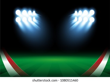 Red and white flags on football field with bright stadium lights