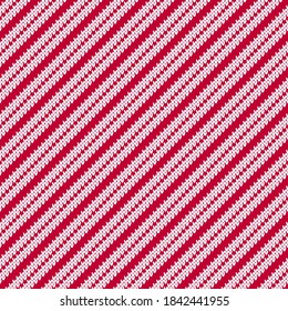 Tejido de rayas diagonales de punto rojo y blanco sin inconvenientes. El invierno neutro tejió el patrón texturizado con rayas blancas de caramelo sobre un fondo rojo.
