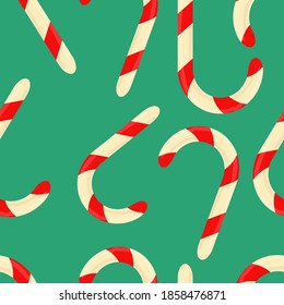 Red and white lollipops on a green background. Vector seamless pattern for printing on wrapping paper, pajamas, pillows. Suitable for the new year.