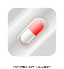Red and white medicine capsule, pill in blister isolated on white