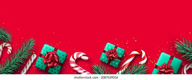 Red and white striped candy cane sticks with fir branches and gift boxes. Red background. Space for text. Vector illustration.