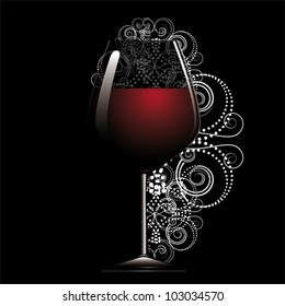 Red wine in glass on black back.