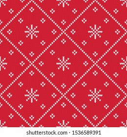 Red winter holiday knitted diamond pattern. Christmas seamless vector pattern with knitted texture. Cute festive background with snowflakes and stars.