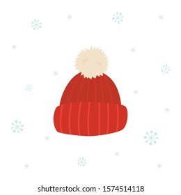 Red winter knitted hat with snowflakes on white background.