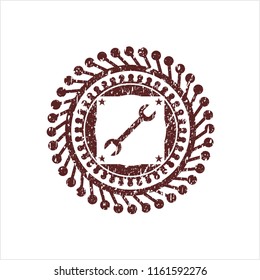 Red wrench icon inside rubber grunge seal