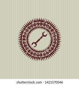Red wrench icon inside rubber grunge texture seal