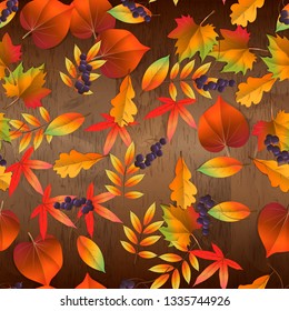 red and yellow autumn leaves. vector seamless pattern on wooden background