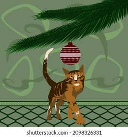 A Red-Haired Cat Is Going To Play With A Christmas Tree Toy